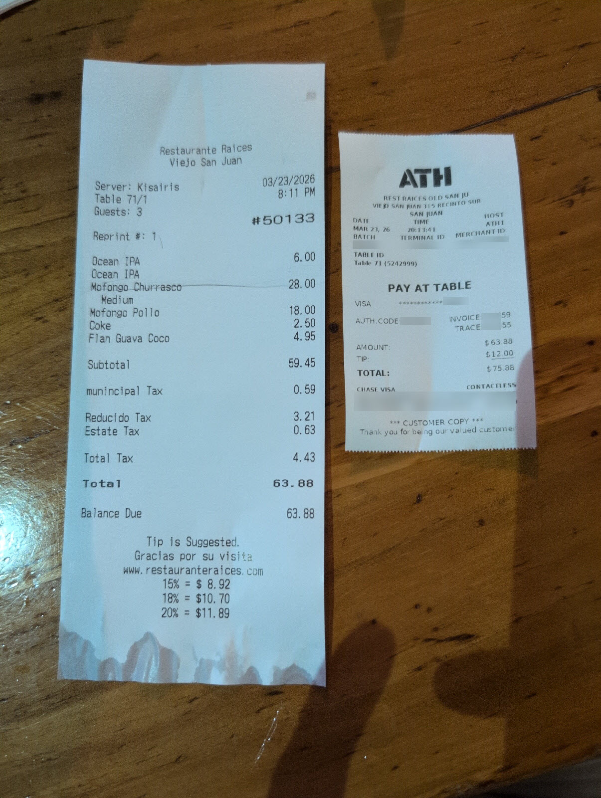 Restaurant receipt with split tip across companion slips